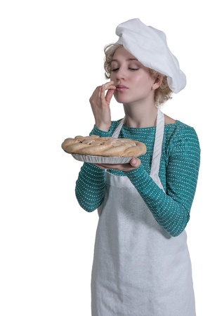 Beautiful woman chef holding a freshly baked pieの写真素材