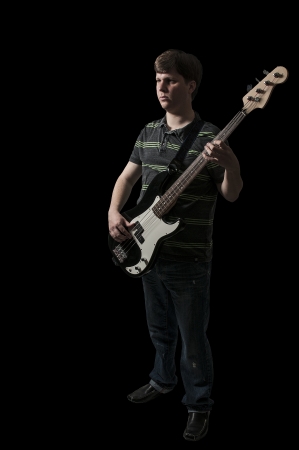 Young man holding a bass guitar musical instrument