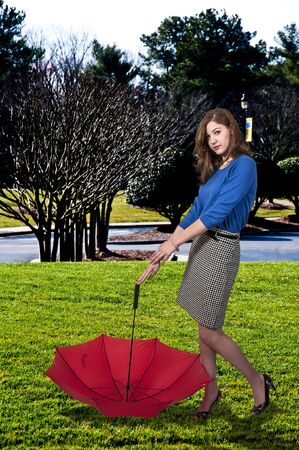 A beautiful woman holding a colorful umbrellaの写真素材