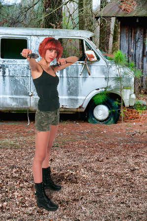 Beautiful police detective woman on the job with a gunの写真素材