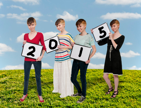 Beautiful young woman holding up a blank signの写真素材