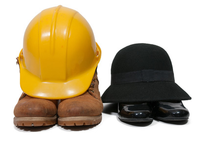 Steel toe work boots yellow hard hat cloche hat and black high heel shoesの写真素材