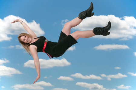 Beautiful young woman falling through the sky