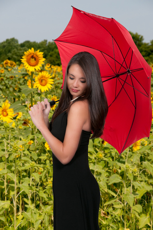Beautiful woman holding a colorful rain umbrellaの写真素材
