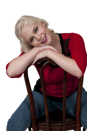 Young Beautiful Woman sitting in a cane back chairの写真素材