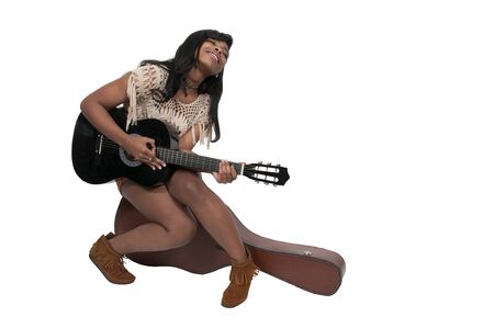 Beautiful young woman playing an acoustic guitarの写真素材