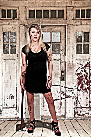 Beautiful possessed woman in a trance holding an axeの写真素材