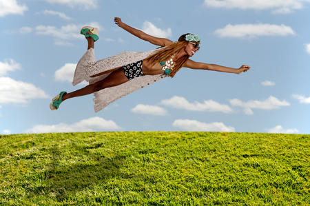 Beautiful young woman flying or falling through the airの写真素材