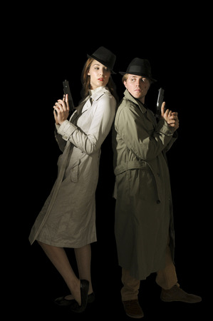 Man and woman secret agent spies with gunsの写真素材