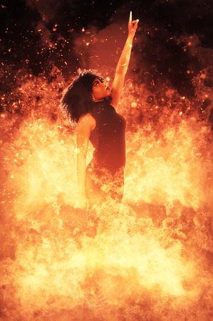 Beautiful woman standing in the midst of a fireの写真素材