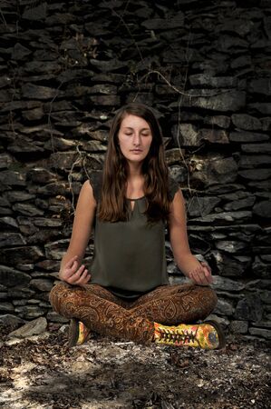 Beautiful woman doing her Yoga lotus position exercisesの写真素材