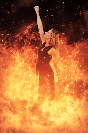 Beautiful woman standing in the midst of a fireの写真素材