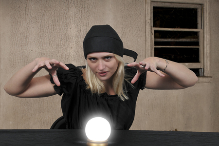Woman gypsy fortune teller using a crystal ballの写真素材