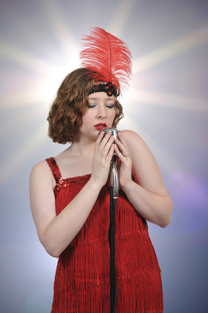 Beautiful woman singer performing with a vintage microphone