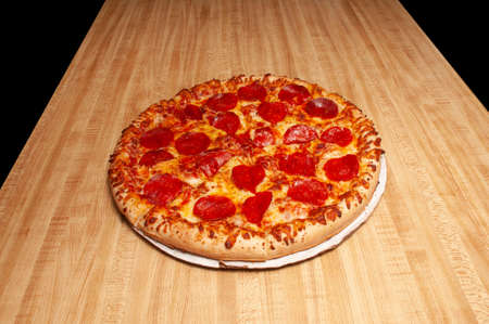 Delicious tomato sauce cheese covered hot and tasty pepperoni pizza pieの写真素材