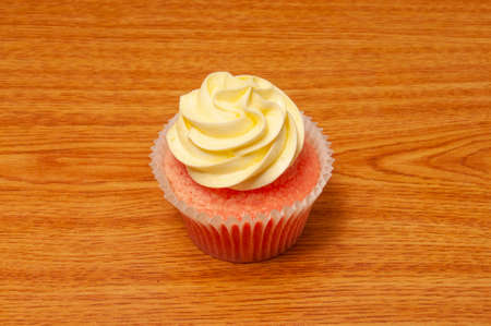 Delicious bakery product known as the butter crean frosting strawberry cupcakeの写真素材
