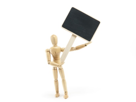 wooden doll with poster board on white backgroundの写真素材