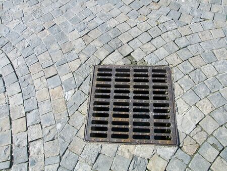 sewer cover at paved stone in palencia,españaの写真素材