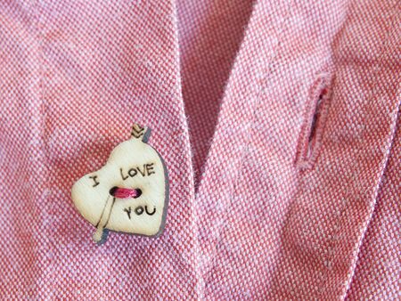 heart shaped button with printed text