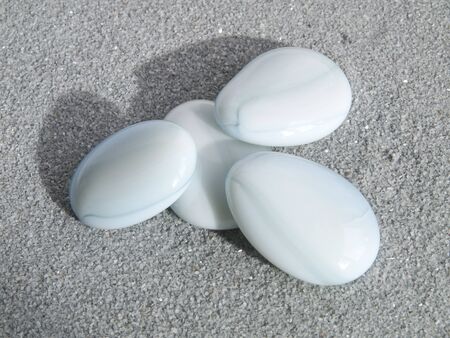 blue round stones on gray sandの写真素材