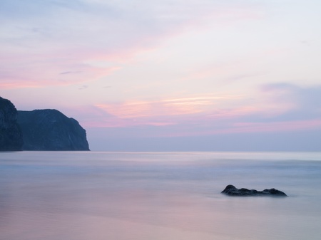 sunset over the sea on the beach in vidiago, coast of Asturias, Spainの写真素材