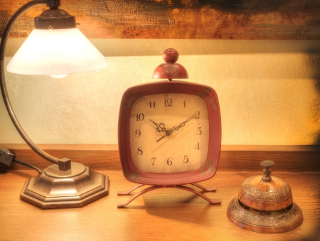 antique clock with bell and vintage lampの写真素材