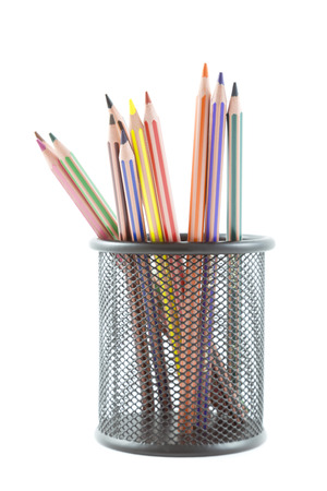 colored pencils in pot rack over white backgroundの写真素材