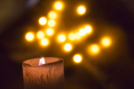 candle with blurred lights in backgroundの写真素材