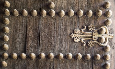 Rustic red door with wrought iron rivets in sevilla, spainの写真素材