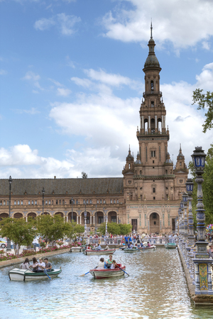 SEVILLA, SPAIN - APRIL 28, 2018: Tourists float on a boat on the canal Spanish Square (Plaza de Espana), Spain on April 28, 2018のeditorial素材