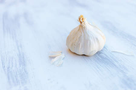 garlic against light and vintage background out of focus, white and blue. copy spaceの写真素材
