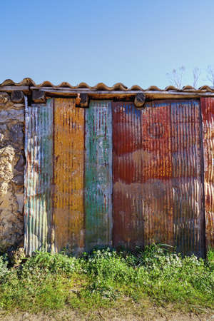 Rusty colored metal door. Old door, rusty metal and peeling paintの写真素材