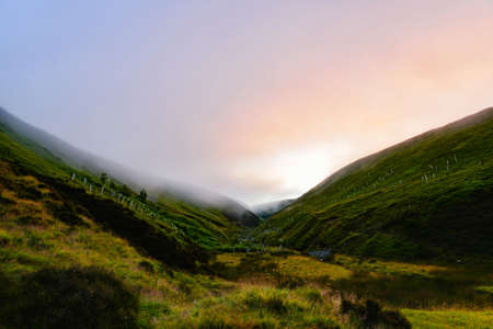 misty sunrise in the mountainsの写真素材