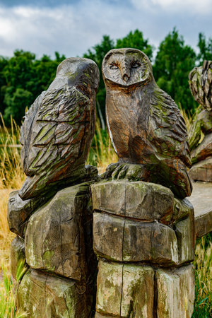 A bench by the lake with sculpturesの写真素材