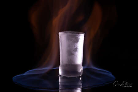 Glass in flames on a dark background with reflection.の写真素材