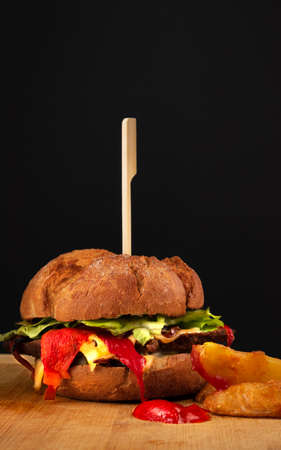 Burger with french fries on a wooden bottom.の写真素材