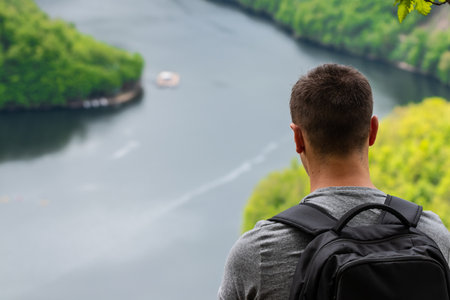 man looking at the lakeの写真素材