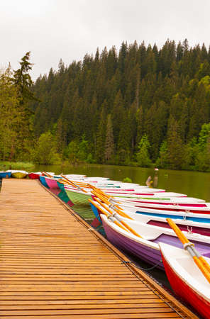 Colorful boats on the lake. Red Lake, Romania.の写真素材