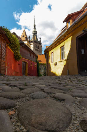 The medieval town, Sighisoara, Romania. The castle from Sighisoara, Colorful houses. Paved road.の写真素材