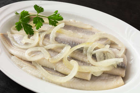 herring marinated in oil with onionの写真素材