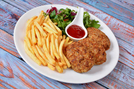 minced cutlets with french fries and lettuce
