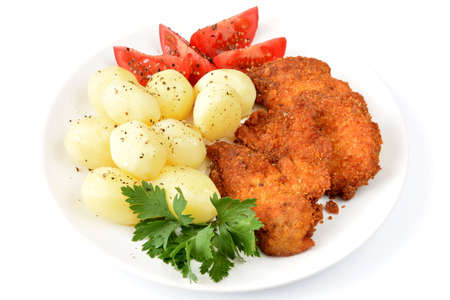 fried chicken fillets with potatoes and tomatoの写真素材