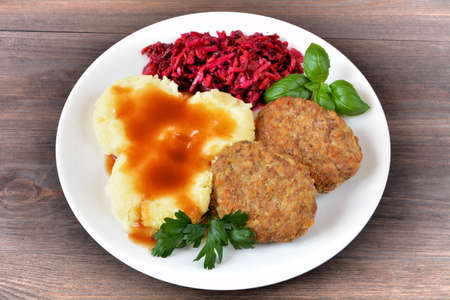 minced cutlets with potatoes, sauce and saladの写真素材