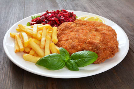 cutlet with fries and saladの写真素材