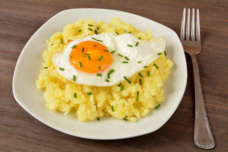 fried egg with potatoesの写真素材