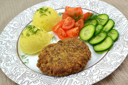 minced cutlet with potatoes, cucumber and tomato