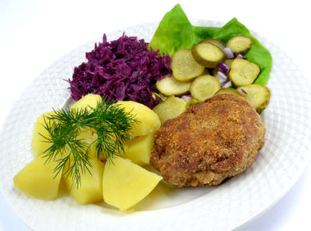 minced cutlet with potatoes, cucumber and cabbageの写真素材