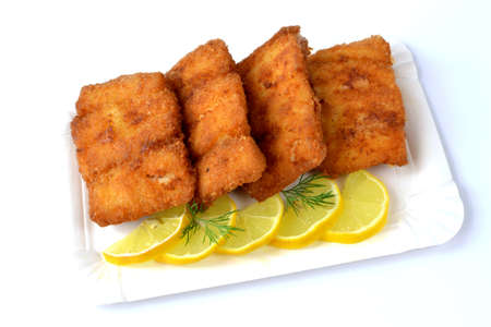 fried miruna fillet on a white plateの写真素材
