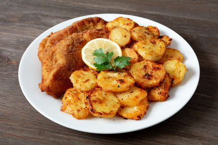 fried chicken fillet with baked potatoesの写真素材