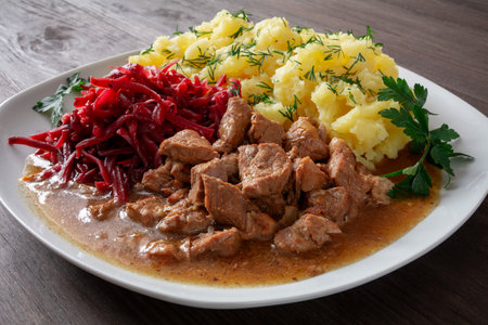 pork goulash with potatoes and beetroot saladの写真素材